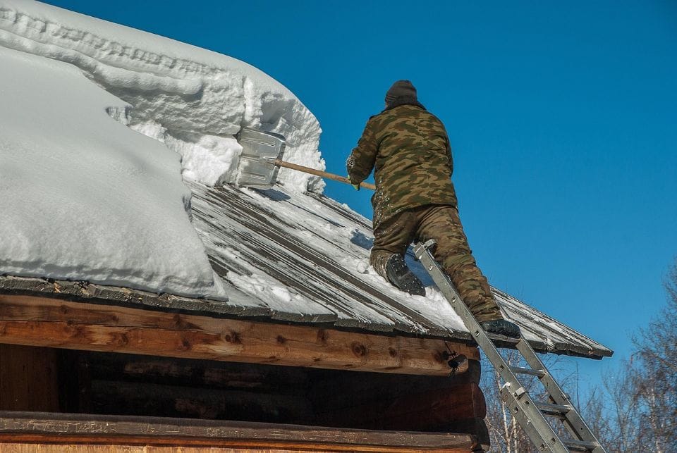 shovelling snow from a roof in Orangeville