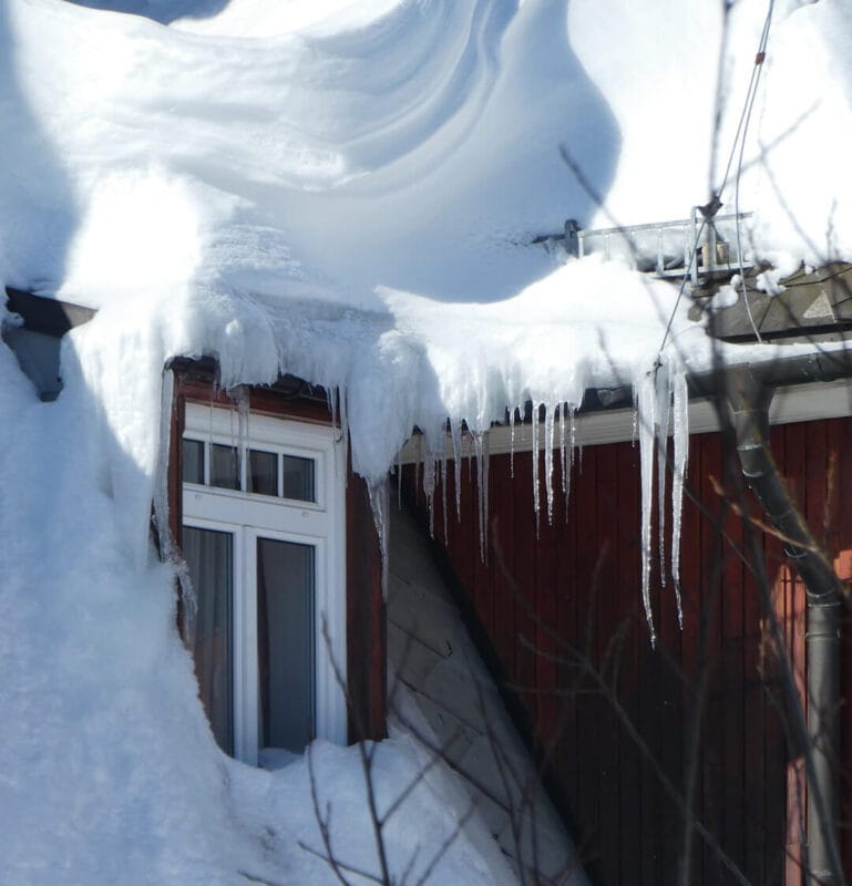 Synergy Exteriors - water dam and snowy roof